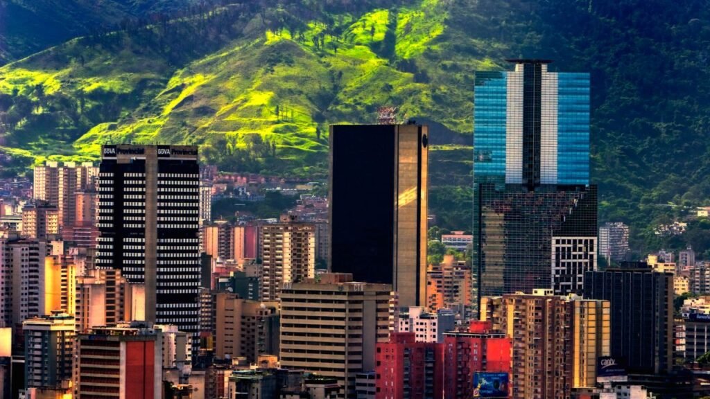 Caracas city skyline with modern skyscrapers set against a lush green mountainside in Venezuela