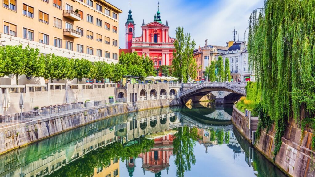 Triple Bridge and Franciscan Church of the Annunciation reflected in the Ljubljanica River, Ljubljana, Slovenia