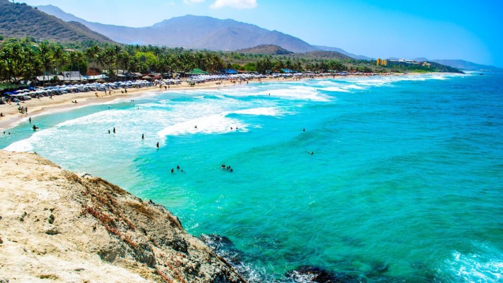 Aerial view of a crowded sandy beach and turquoise Caribbean Sea along Margarita Island, Venezuela
